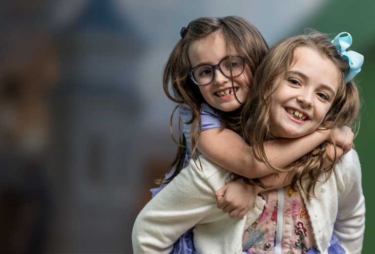 Gabby and her sister hugging in Arnold Palmer Hospital