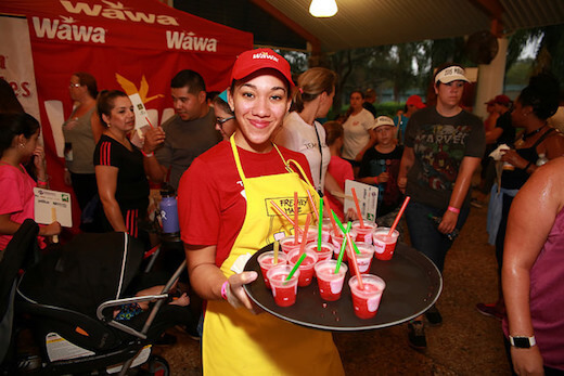 Wawa employee holding tray of drinks
